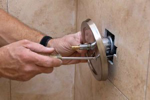 Installing a chrome shower knob in Surfside